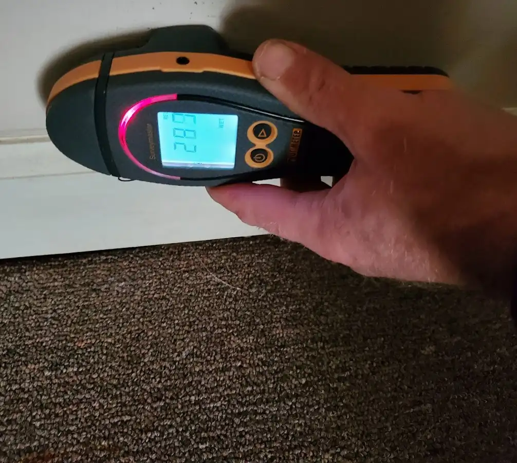 Moisture detection at baseboard during Storm Damage Restoration in Ballenger Creek